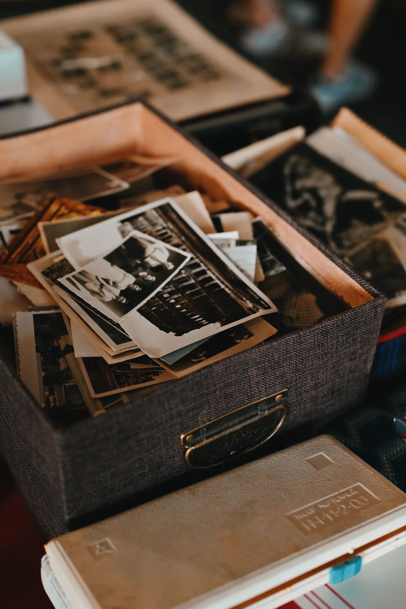 A box of old family photographs and documents from a family archive