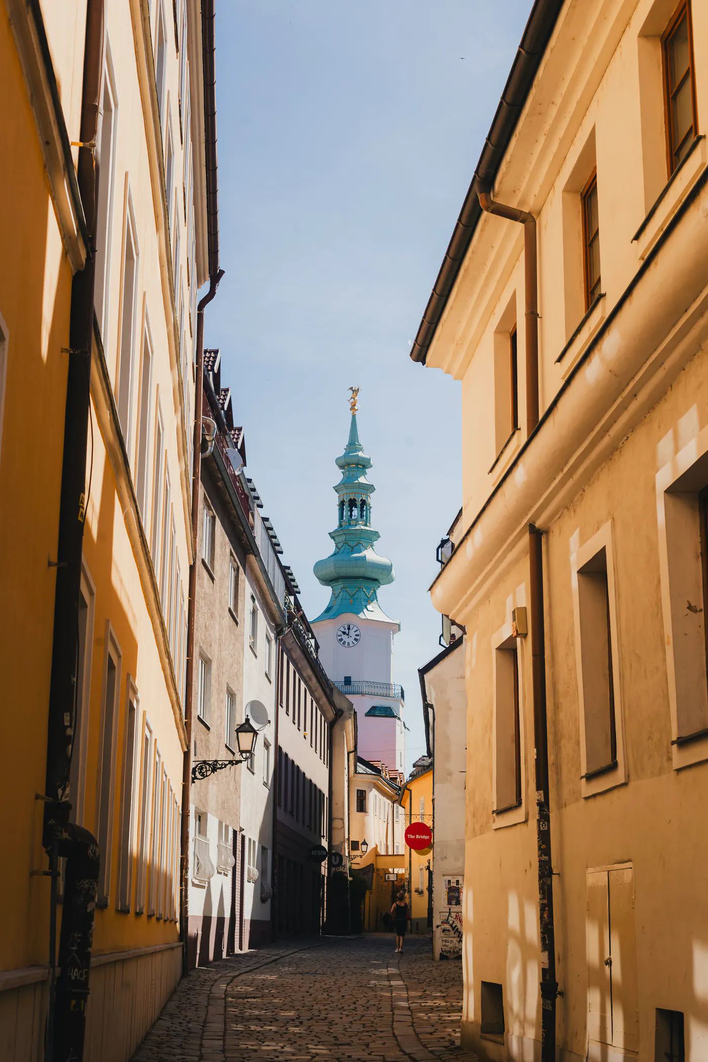 A cobbled street in Bratislava's old town, looking towards St Michael's Gate